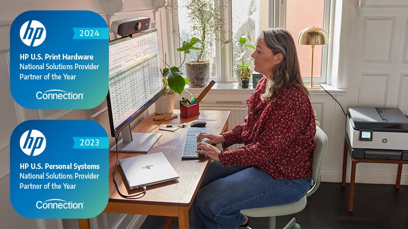 Woman using HP products - laptop, monitor and printer