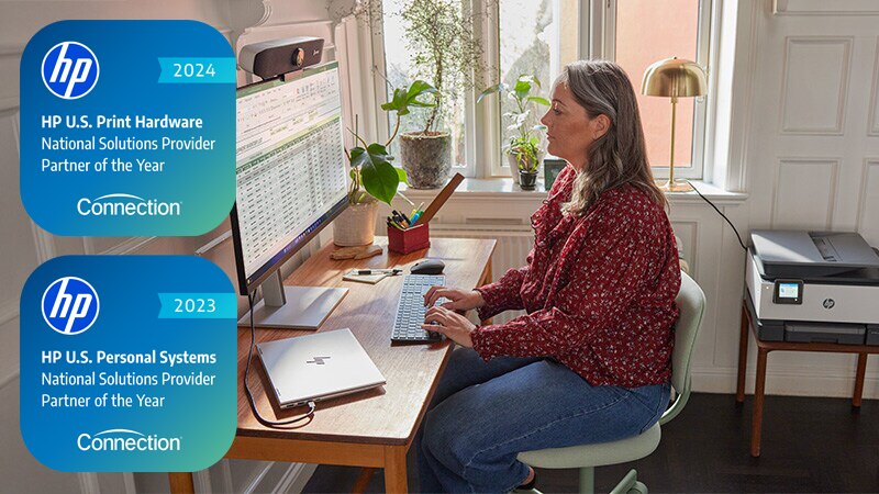 Woman using HP products - laptop, monitor and printer